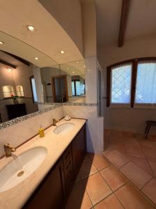 a bathroom with two sinks and a large mirror at Villa La Giulia in Cerveteri +126 photos