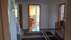 a hallway with a door and a room with a rug at Apartman Ružica in Tomislavgrad