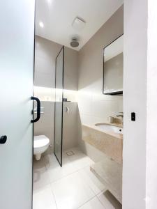 a bathroom with a toilet and a sink at Pyramids Spiritual Hotel in Cairo +17 photos