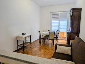 a living room with a table and chairs and a couch at Monviso in Fossano +4 photos
