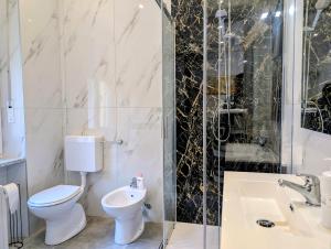 a bathroom with a toilet and a sink and a shower at Monviso in Fossano