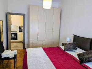 a bedroom with a large bed and a kitchen at Monviso in Fossano