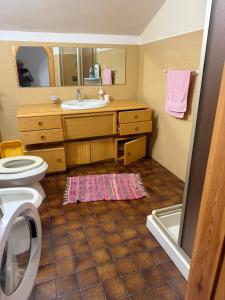 a bathroom with a sink and a toilet at La mansarda in Miranda +18 photos