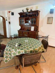 a room with a table and chairs and a cabinet at La mansarda in Miranda