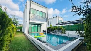 a house with a swimming pool in the backyard at Villa Marcy in Belek