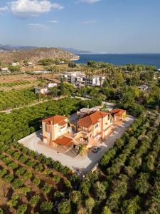 an aerial view of a house with the ocean in the background at Maria's Filoxenia Suites in Drepana