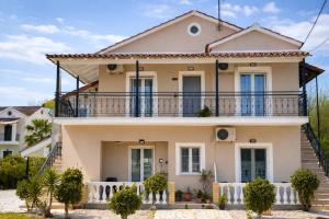 a house with a balcony on top of it at Euphoria Suites and Studios in Sidari +45 photos
