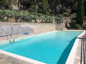 a large swimming pool with blue water at Casa Lilli in Vallecrosia