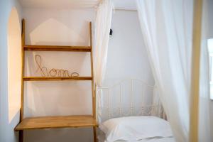 a bedroom with a bunk bed and a shelf at Casa Amore in Ermoupoli