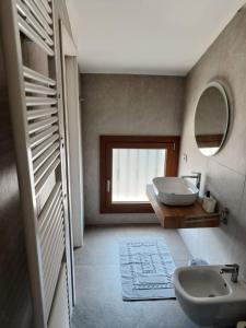 a bathroom with a sink and a mirror at Villa Ander in Colà di Lazise