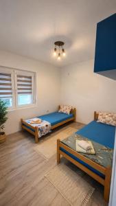 a room with three beds in a room at Villa Milla near Autopat e 75 in Veles