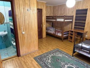 a room with two bunk beds and a bathroom at Hotel palas tatarıv in Tatariv +2 photos
