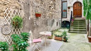 a patio with a table and some plants and a building at Nel Borgo di San Francesco - Ospitalità Diffusa - Relax tra Roccaraso e Costa dei Trabocchi in Villa Santa Maria