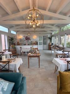 a dining room with tables and a chandelier at ORTO NOTO - Agri Resort in Noto