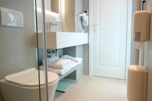 a bathroom with a toilet and a sink and a mirror at Centrale Hotel in Tirana +60 photos