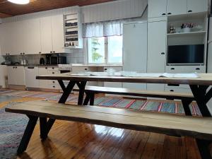 a wooden table in a kitchen with a wooden floor at Pielinen in Lieksa