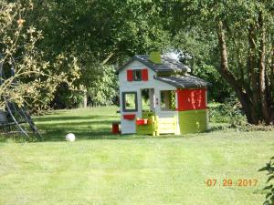 a small toy house sitting in the grass at Les Six Vallées in Ramillies