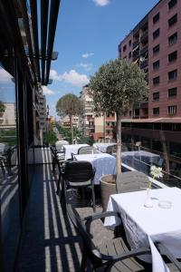 a row of tables and chairs on a balcony at Centrale Hotel in Tirana