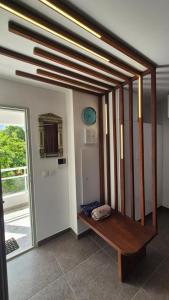 a room with a wooden bench in a room at ONLY4VIEW Beach Front in Sainte-Anne