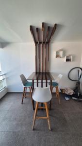 a table and four chairs in a room at ONLY4VIEW Beach Front in Sainte-Anne +10 photos