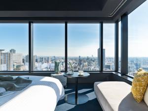 a bedroom with a bed and a table at Mitsui Garden Hotel Nagoya Premier in Nagoya