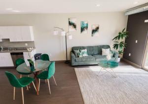 a living room with a couch and a table and chairs at Evergreen Nook in Des Moines