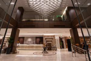 a lobby of a hotel with a chandelier at Mora Hotel in Jeddah +31 photos