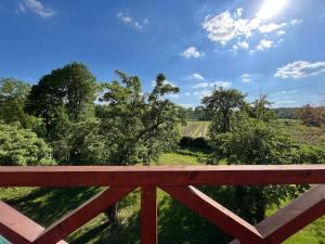 a wooden fence with a view of a field at Agroturystyka Borów - pokoje in Prusice