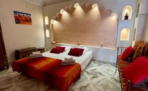 a hotel room with two beds and a couch at Riad Les Chtis D'Agadir in Agadir +89 photos