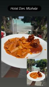 a plate of food with pasta and meat on it at Hotel Don Michele in Boca Chica