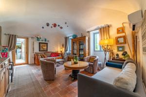 a living room with a couch and a table at Mas Escombelle in Barjac