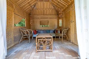 a room with a table and chairs and a couch at Mas Escombelle in Barjac