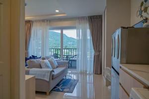 a living room with a couch and a large window at The Terraza Condotel in Nathon Bay