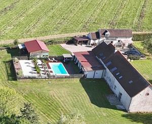 an aerial view of a house in a field at Relais du Chat Prosper in Lescherolles