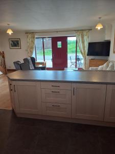 a kitchen with a large island in a living room at Glen Lyon in Inverurie