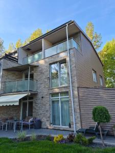 an apartment building with a balcony and a patio at Pas Rasą in Palanga