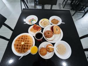 a table with plates of breakfast food on it at Admiralty Inn & Suites - a Red Collection Hotel in Falmouth