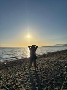 a woman standing on the beach watching the sunset at Medecielo Villa in San Fernando +1 photo