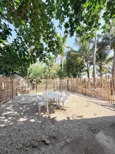 a table and two chairs in front of a fence at Medecielo Villa in San Fernando
