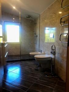 a bathroom with two toilets and a tub and a window at Sunny seaside place in Jūrmala +18 photos