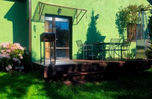 a patio with a table and chairs in front of a building at Sunny seaside place in Jūrmala