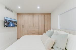 a bedroom with a large white bed with white pillows at Villa Verde - Boca Pool & Beach Walk in Boca Raton
