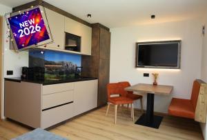a living room with a television and a table at Apartments Silvonia in Pallua
