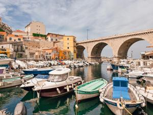 a bunch of boats in a harbor with a bridge at Sublime chambre à endoume proche mer in Marseille
