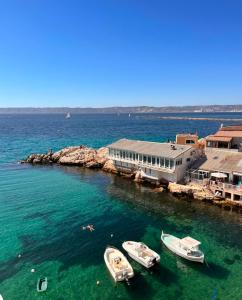 a group of boats in the water near a dock at Sublime chambre à endoume proche mer in Marseille