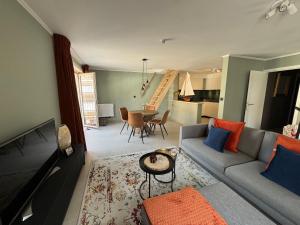a living room with a couch and a table at Relax & Sea in Ostend +15 photos
