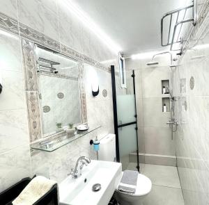 a white bathroom with a sink and a toilet at Luxury house near by Delphi in Kírra +50 photos