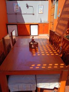 a large wooden table in a room with a television at EXPONOR 2026 Casa 3D 2B in Antofagasta
