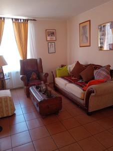 a living room with a couch and a chair at EXPONOR 2026 Casa 3D 2B in Antofagasta +3 photos