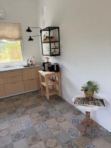 a kitchen with a tiled floor and a counter at Casita Malacitano, Caminito del Rey in Valle de Abdalagís +15 photos